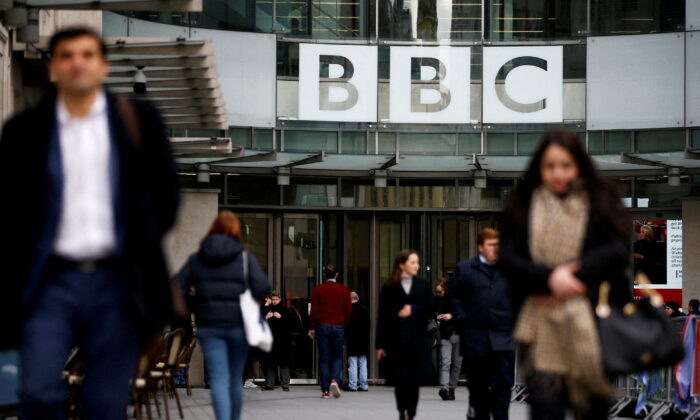 Pedestrians walk past a BBC logo at Broadcasting House in London, Jan. 29, 2020. (Reuters/Henry Nicholls/File Photo)
