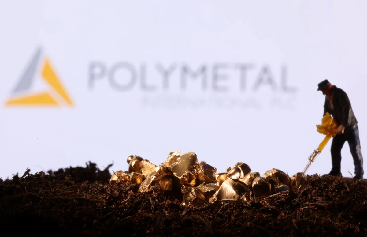A small toy figure and gold imitation in front of the Polymetal logo in a photo illustration taken on Nov. 19, 2021. (Dado Ruvic/Reuters)