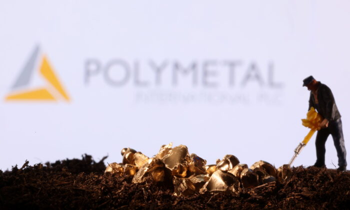A small toy figure and gold imitation in front of the Polymetal logo in a photo illustration taken on Nov. 19, 2021. (Dado Ruvic/Reuters)