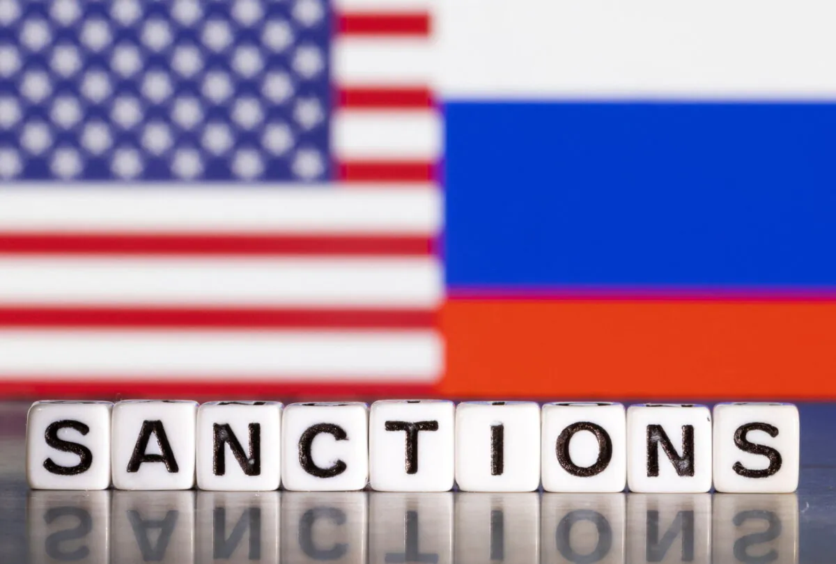 Plastic letters arranged to read "Sanctions" are placed in front the flag colors of U.S. and Russia in this illustration taken Feb. 28, 2022. (Reuters/Dado Ruvic/Illustration)