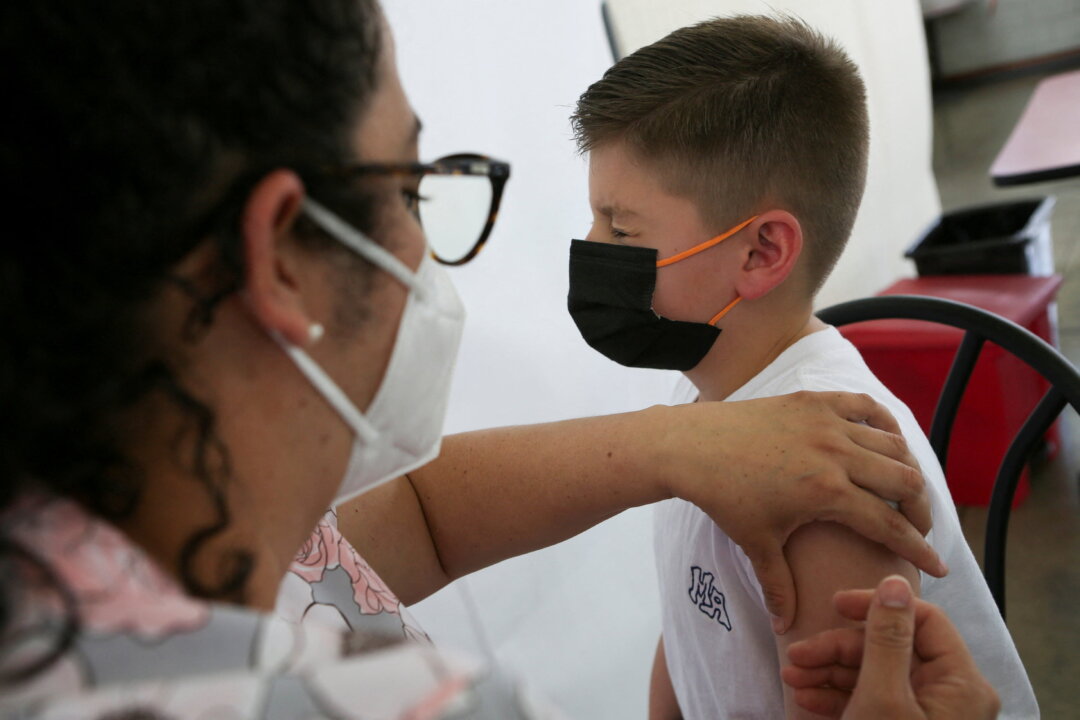 A child is administered a dose of the Pfizer-BioNTech coronavirus disease (COVID-19) pediatric vaccine, in San Jose, Costa Rica on Feb. 23, 2022. (Mayela Lopez/Reuters)