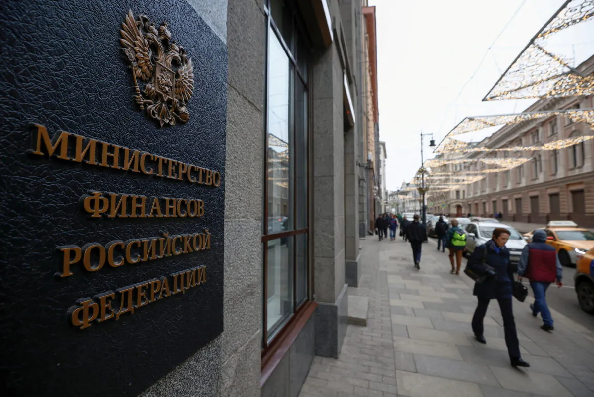 Pedestrians walk past Russia's Finance Ministry building in Moscow, Russia, on March 30, 2021. (Maxim Shemetov/Reuters)