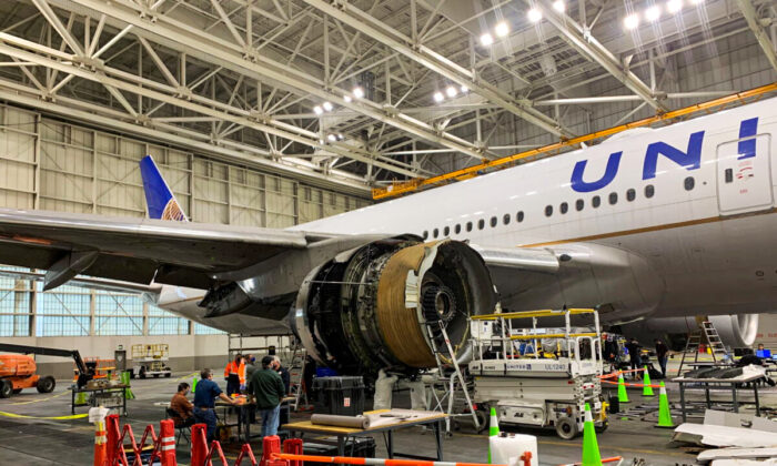 The damaged starboard engine of United Airlines flight 328, a Boeing 777-200, is seen following a February 20 engine failure incident, in a hangar at Denver International Airport in Denver, Colorado, U.S. February 22, 2021. National Transportation Safety Board/Handout via REUTERS.  THIS IMAGE HAS BEEN SUPPLIED BY A THIRD PARTY.  MANDATORY CREDIT