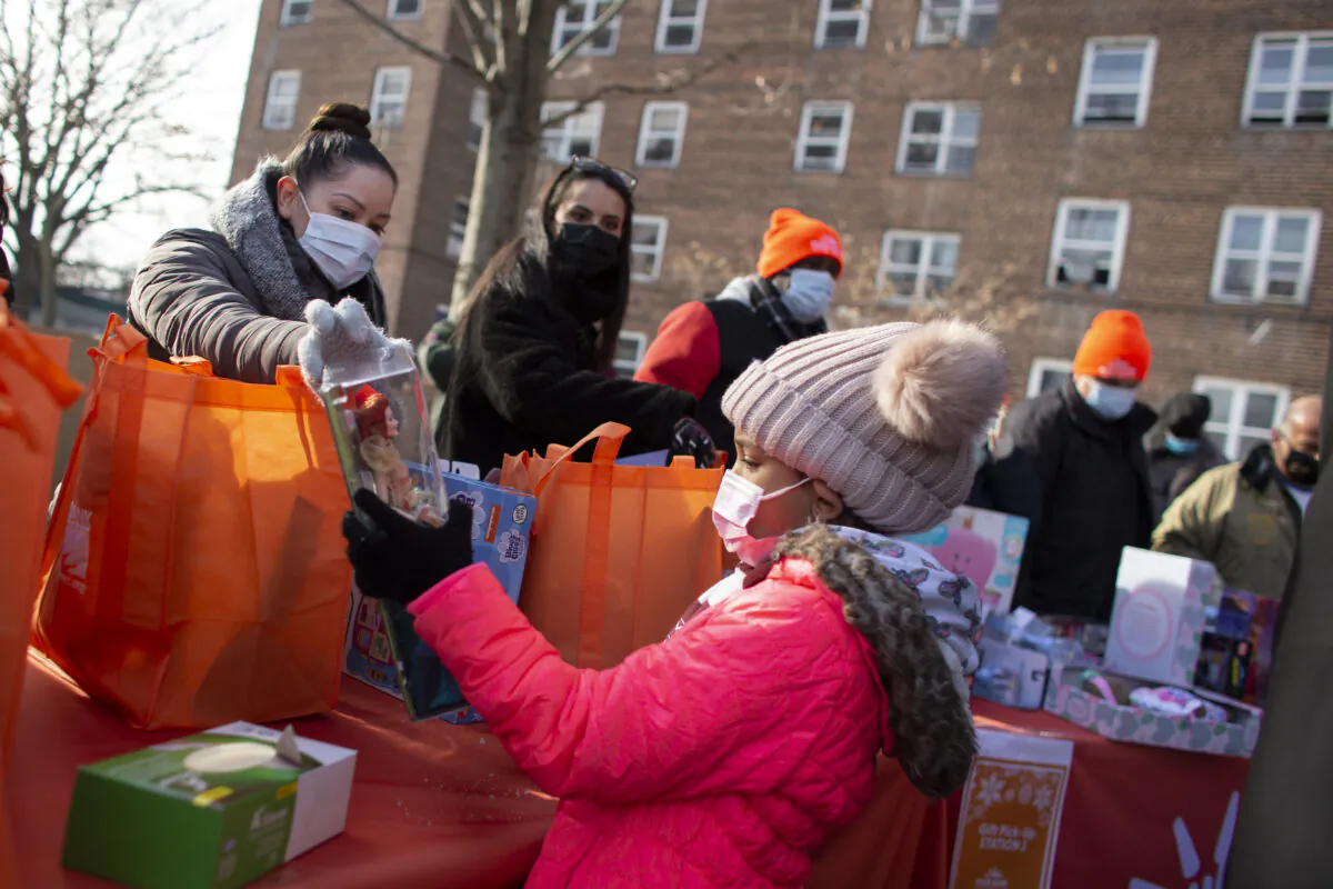 A girl receives a gift during a giveaway for people in need in a file photo. (Kena Betancur/AFP via Getty Images)