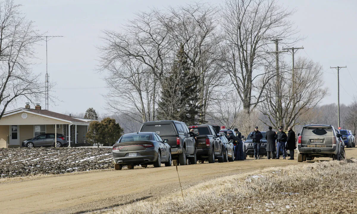 Law enforcement work the scene after a Lapeer County Sheriff's Deputy was shot serving a warrant in Brown City, Mich., on March, 9, 2022. (Jenifer Veloso/The Flint Journal via AP)