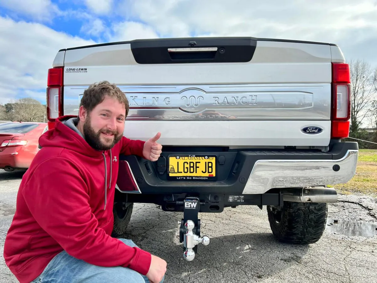 Nathan Kirk poses with his license plate that the state of Alabama finds "objectionable" on Feb. 25, 2022 (James Nicholas, Blount County Tactical)