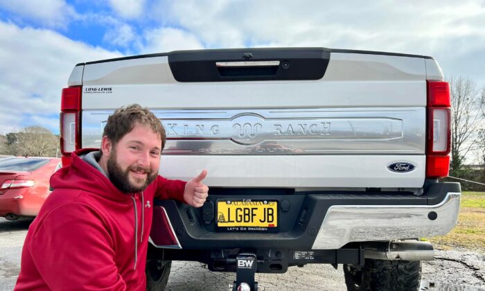 Nathan Kirk poses with his license plate that the state of Alabama finds "objectionable" on Feb. 25, 2022 (James Nicholas, Blount County Tactical)