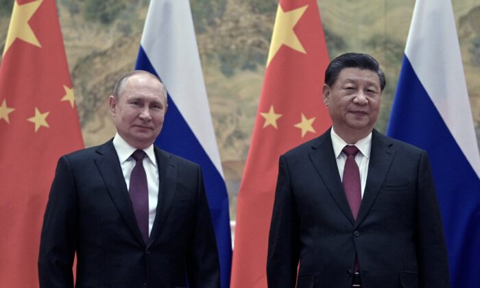 Russian President Vladimir Putin (L) and Chinese leader Xi Jinping pose during their meeting in Beijing on Feb. 4, 2022. (Alexei Druzhinin/Sputnik/AFP via Getty Images)
