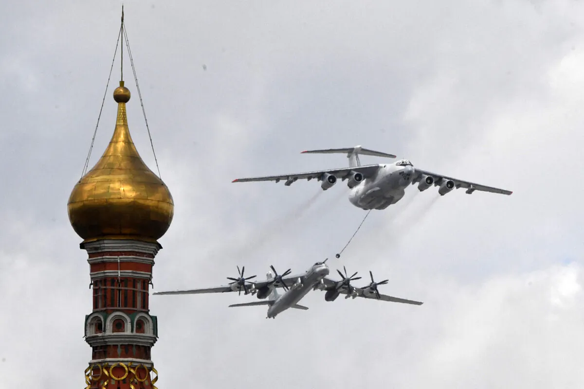 A Russian Tu-95MS strategic bomber and an Ilyushin Il-78 aerial refuelling tanker fly over the Kremlin and Red Square during a military parade in Moscow on May 7, 2021. (Alexander Nemenov/AFP via Getty Images)