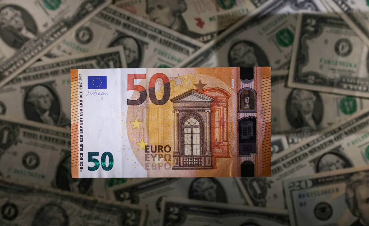 A Euro banknote is seen placed on U.S. Dollar banknotes in this illustration taken on Nov. 28, 2021. (Dado Ruvic/Illustration/Reuters)