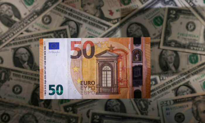 A Euro banknote is seen placed on U.S. Dollar banknotes in this illustration taken on Nov. 28, 2021. (Dado Ruvic/Illustration/Reuters)