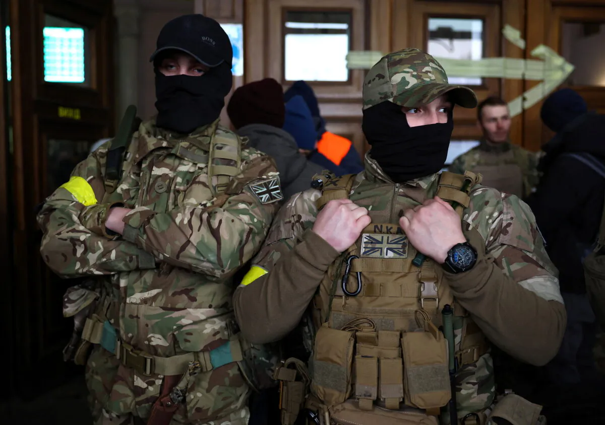 Two foreign fighters from the UK ready to depart toward the front line in Lyiv, Ukraine, on March 5, 2022. (Kal Pfaffenbach/Reuters)