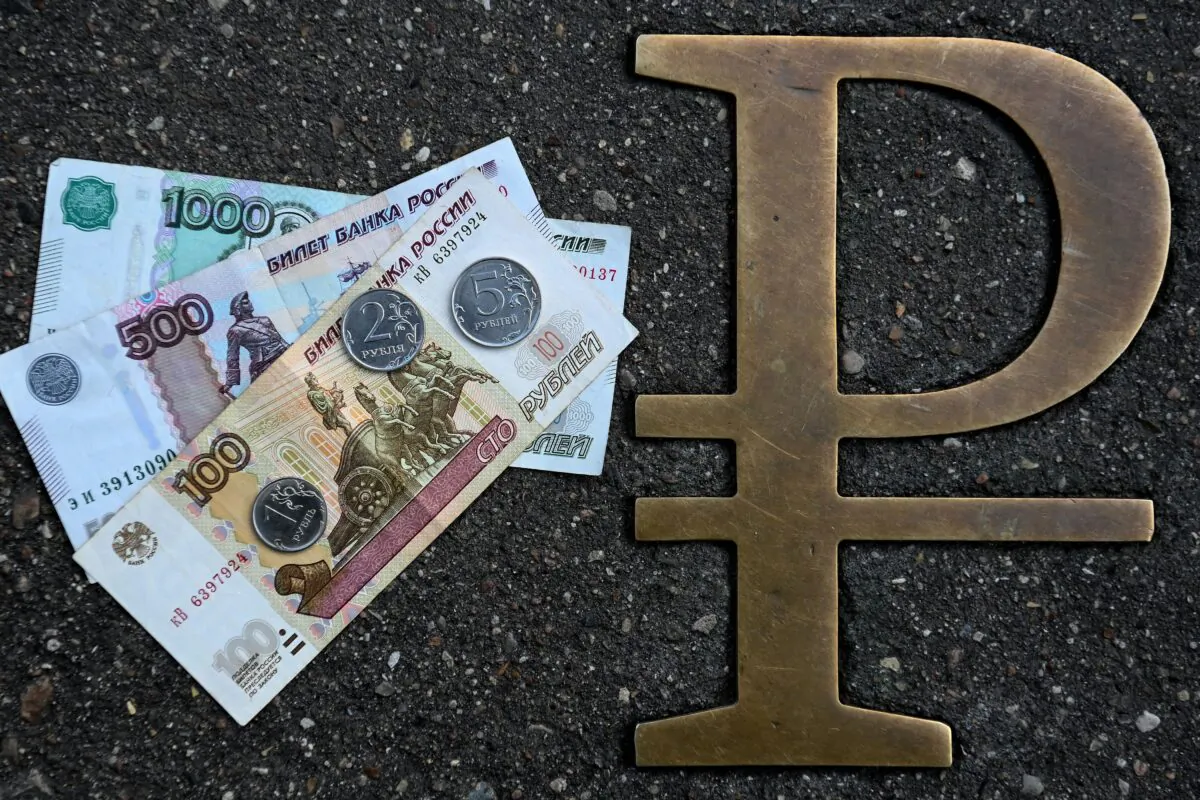 Russian ruble coins and banknotes pictured next to Russian ruble sign in Moscow on Aug. 13, 2021. (Kirill Kudryavtsev/AFP via Getty Images)