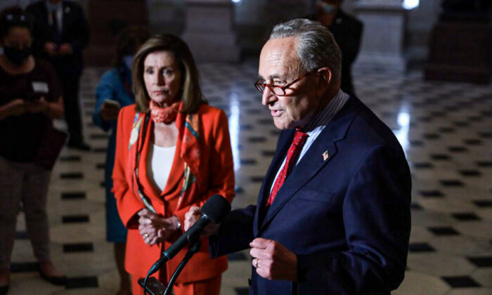 In this file photo, Senate Minority Leader Sen. Charles Schumer (D-N.Y.), right, speaks to reporters as House Speaker Nancy Pelosi (D-Calif.) listens, at the U.S. Capitol in Washington, on Aug. 4, 2020. (Alex Wong/file/Getty Images)