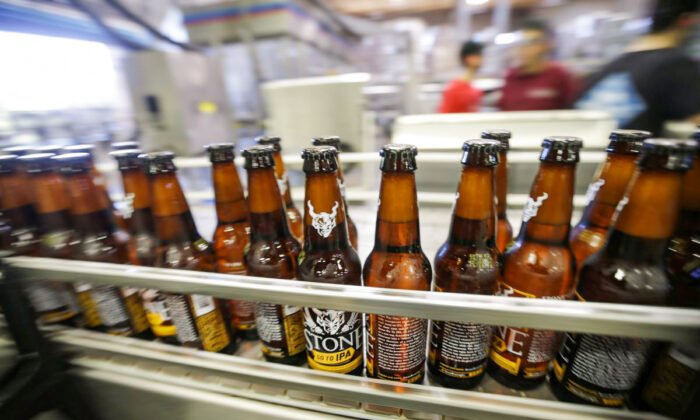 Bottles of beer move along during bottling at Stone Brewing Co. in Escondido, Calif., on Sept. 30, 2015. (AP Photo/Gregory Bull)
