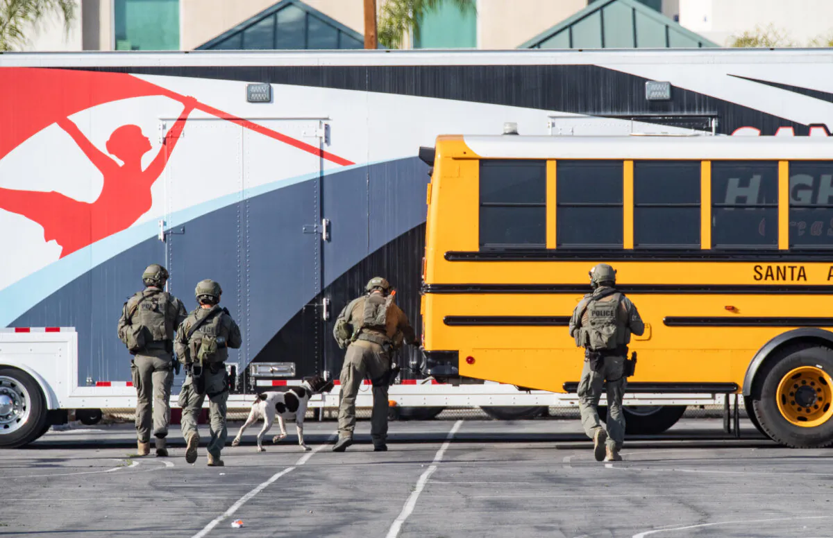 First responders include Santa Ana SWAT teams and Orange County Fire Authority HAZMAT crews secure Santa Ana High School as parents and family members wait for students on lock down after bomb and weapon threats circulated at the school in Santa Ana, Calif., on March 10, 2022. (John Fredricks/The Epoch Times)