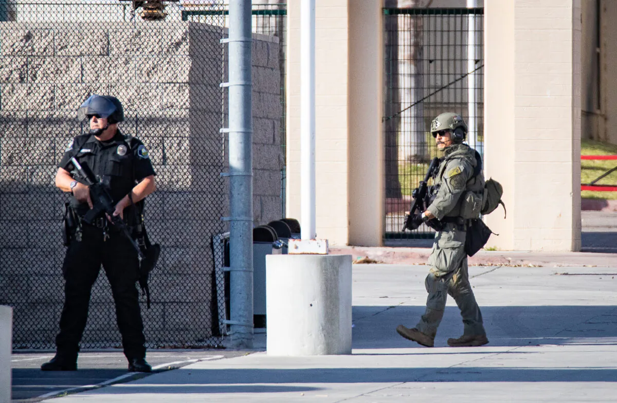 First responders including Santa Ana Police Department SWAT teams and Orange County Fire Authority HAZMAT crews secure Santa Ana High School as parents and family members wait for students on lock down after bomb and weapon threats circulated at the school in Santa Ana, Calif., on March 10, 2022. (John Fredricks/The Epoch Times)