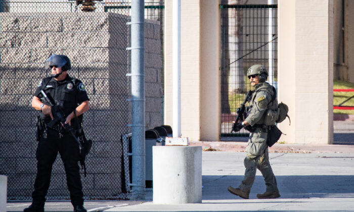 First responders including Santa Ana Police Department SWAT teams and Orange County Fire Authority HAZMAT crews secure Santa Ana High School as parents and family members wait for students on lock down after bomb and weapon threats circulated at the school in Santa Ana, Calif., on March 10, 2022. (John Fredricks/The Epoch Times)