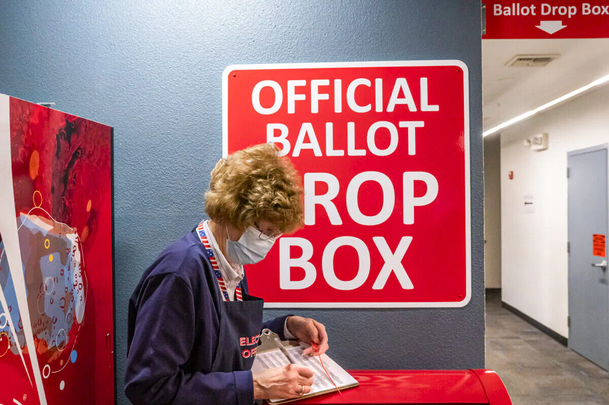 An election worker makes a record of a ballot pickup on Nov. 3, 2020 in Vancouver, Washington. (Nathan Howard/Getty Images)