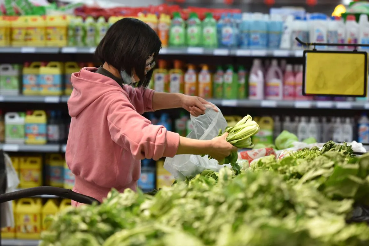 A customer shops for vegetables at a supermarket in Fuyang in China's eastern Anhui Province on March 9, 2022. (STR/AFP via Getty Images)