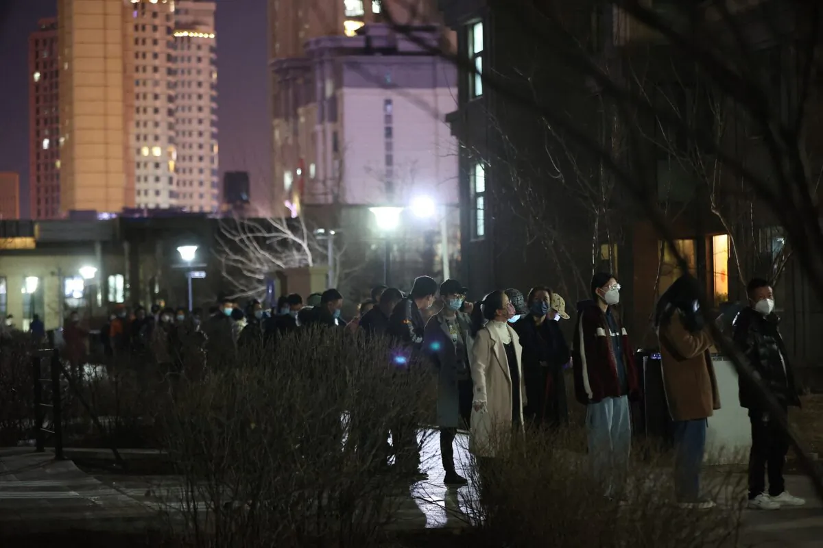 Residents queue to undergo nucleic acid tests for the COVID-19 at a residential area in Changchun city, Jilin Province on March 11, 2022. (STR/AFP via Getty Images)