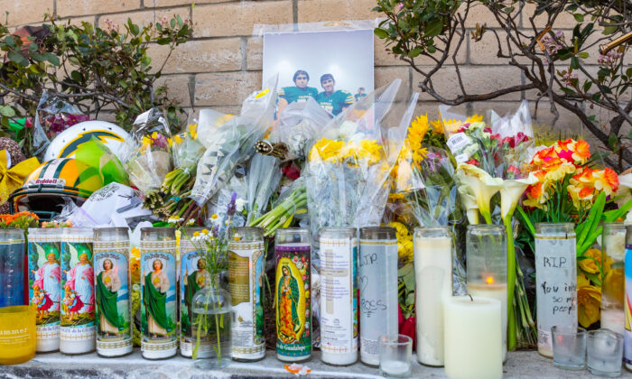 A sidewalk memorial for Josh and Jeremy Page at the intersection of Newland and Yorktown where they were killed in a traffic collision, in Huntington Beach, Calif., on March 10, 2022. (John Fredricks/The Epoch Times)