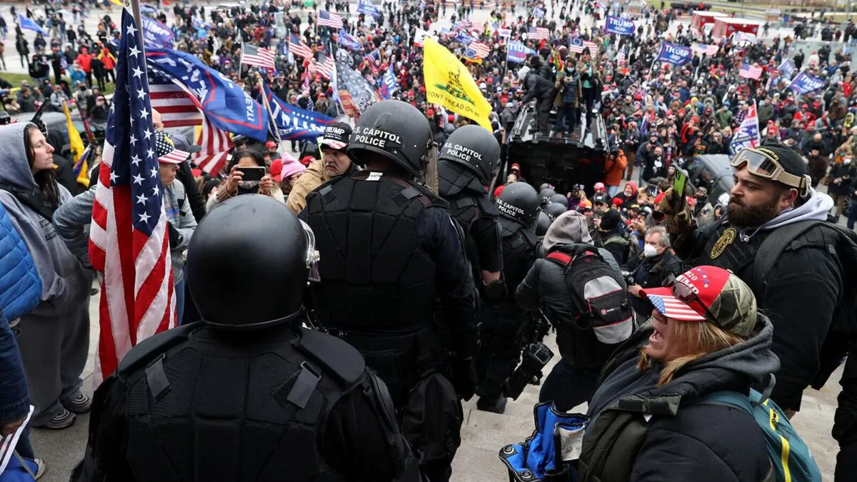 Sixteen Capitol Police officers are led down the east steps of the Capitol by members of the Oath Keepers on Jan. 6. (Courtesy of Roberto Minuta)