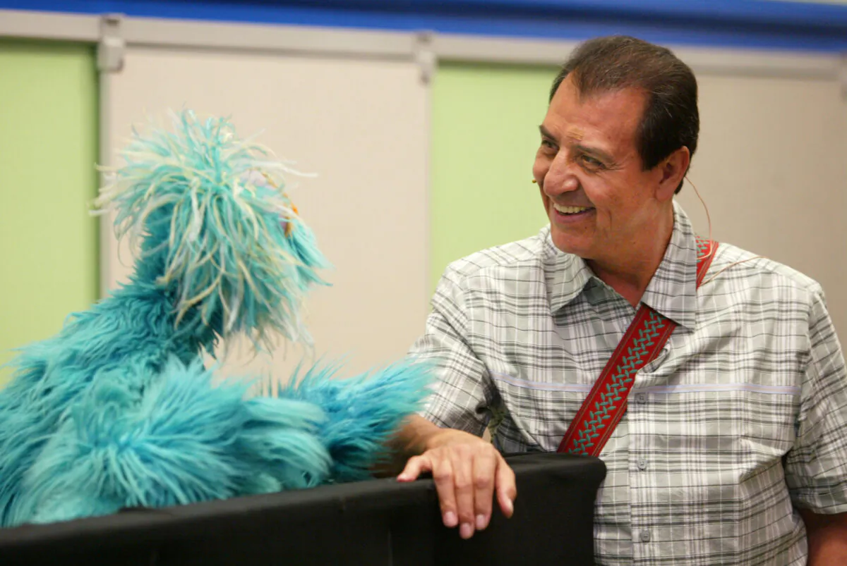 Sesame Street's Luis (R) and Muppet Rosita chat during the introduction of the "You Can Ask!" program in N.Y.C., on June 25, 2003. (Chris Hondros/Getty Images)
