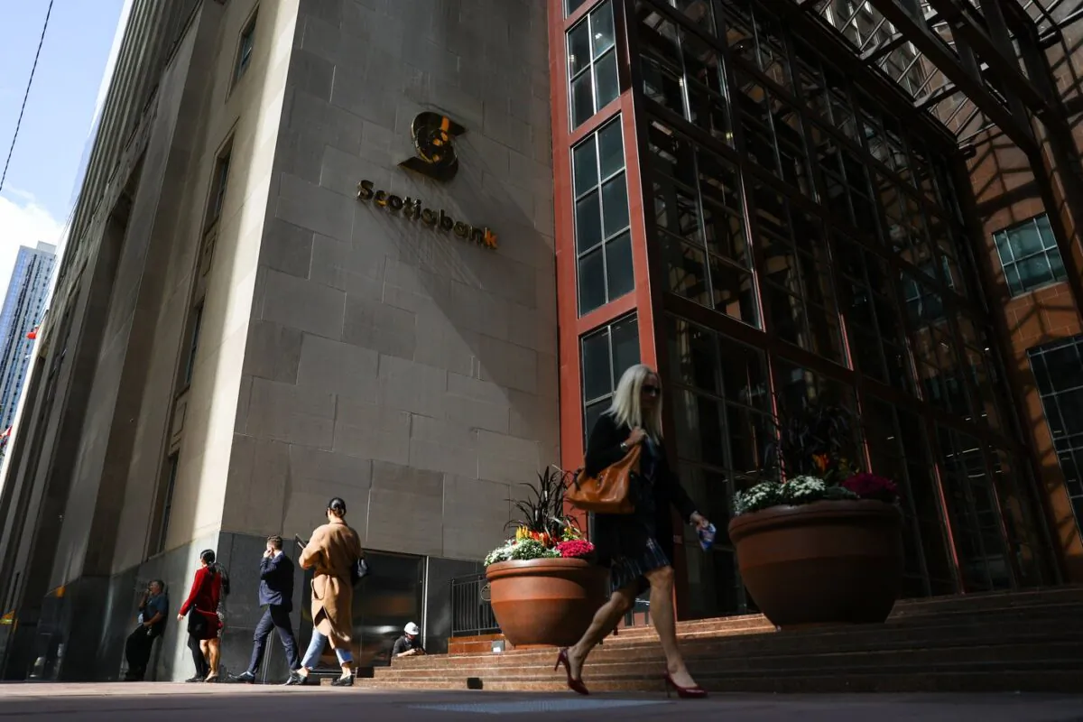 Pedestrians walk past Scotia Plaza in the financial district in Toronto on Sept. 29, 2021. (The Canadian Press/Evan Buhler)