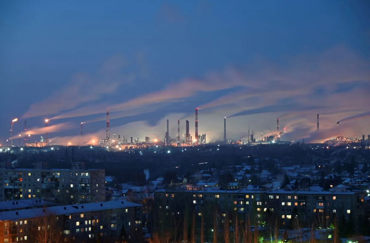 A general view shows a local oil refinery behind residential buildings in Omsk, Russia, on Feb. 10, 2021. (Alexey Malgavko/Reuters)