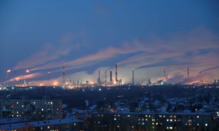 A general view shows a local oil refinery behind residential buildings in Omsk, Russia, on Feb. 10, 2021. (Alexey Malgavko/Reuters)