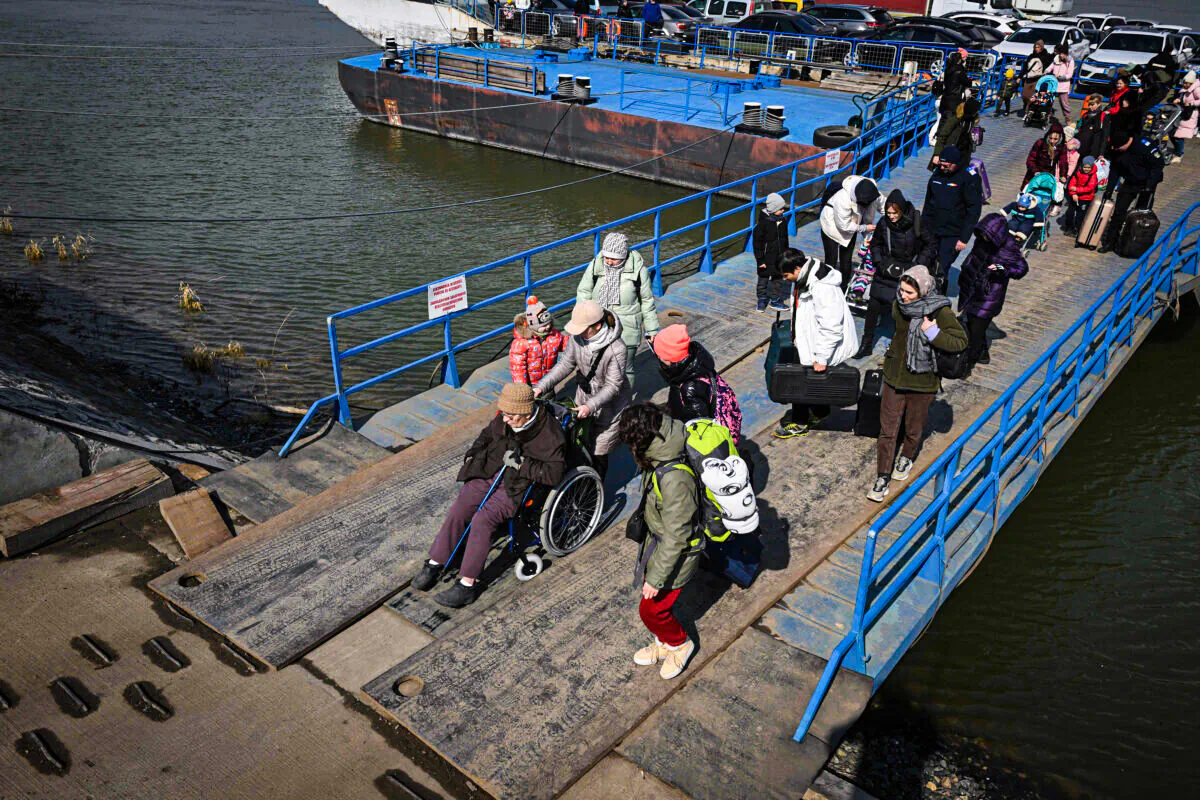 Refugees from Ukraine arrive by ferry at the Romanian–Ukrainian border point Isaccea-Orlovka in Isaccea, Romania, on March 8, 2022. - More than two million people have fled Ukraine since Russia launched its full-scale invasion less than two weeks ago, the United Nations said on March 8, 2022. (Photo by Daniel MIHAILESCU / AFP) (Photo by DANIEL MIHAILESCU/AFP via Getty Images)