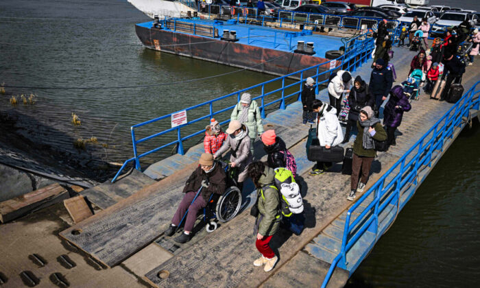 Refugees from Ukraine arrive by ferry at the Romanian–Ukrainian border point Isaccea-Orlovka in  Isaccea, Romania, on March 8, 2022. - More than two million people have fled Ukraine since Russia launched its full-scale invasion less than two weeks ago, the United Nations said on March 8, 2022. (Photo by Daniel MIHAILESCU / AFP) (Photo by DANIEL MIHAILESCU/AFP via Getty Images)
