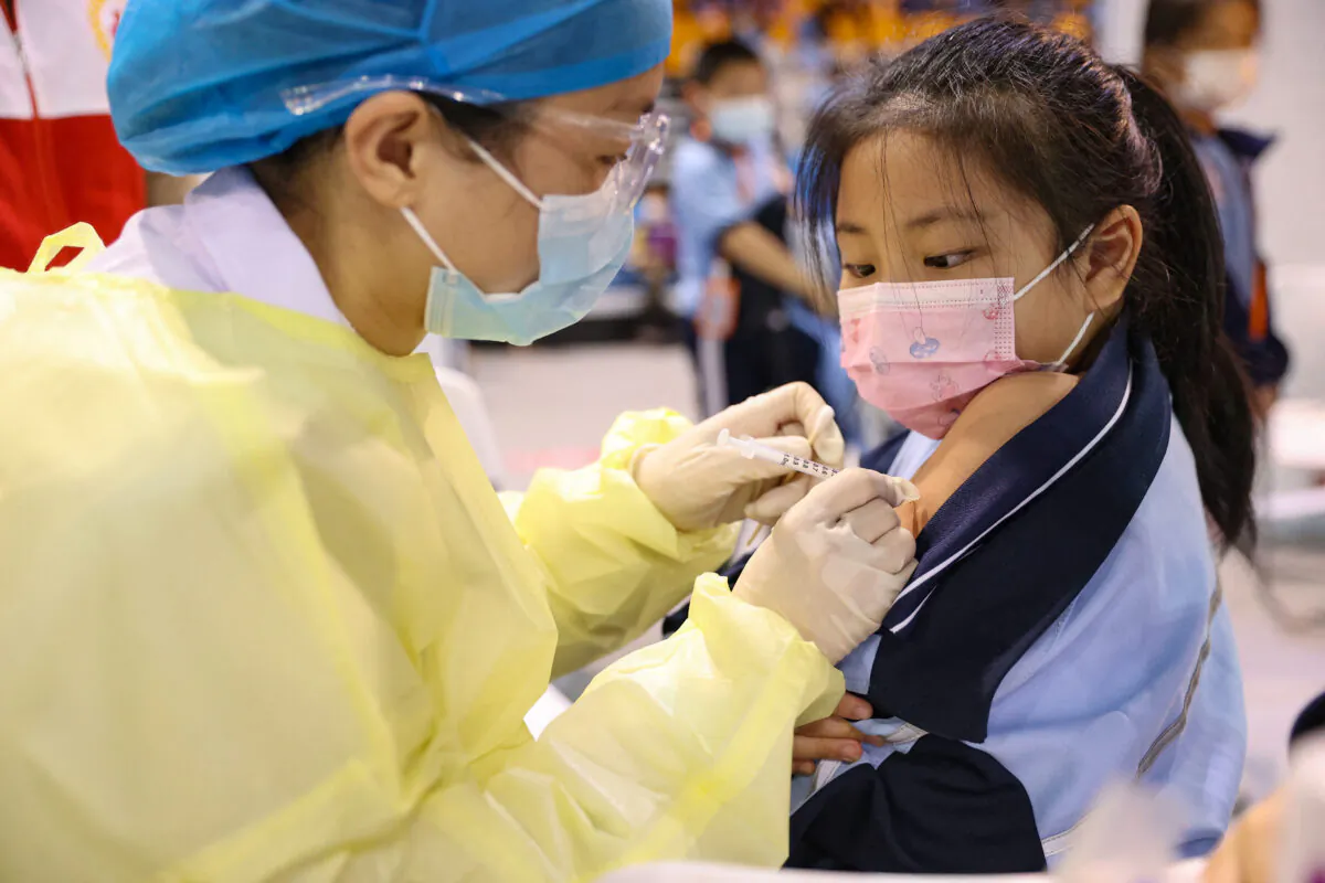 A child receives a COVID-19 vaccine in Xiamen, Fujian Province, on Nov.15, 2021. (STR/AFP via Getty Images)