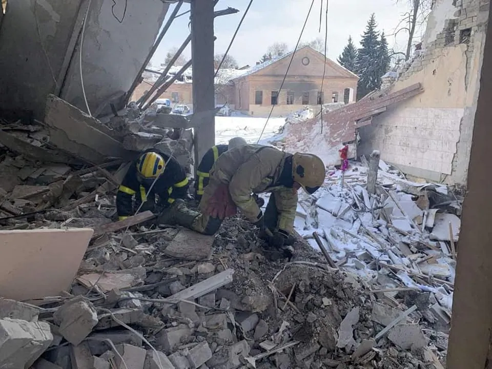 Rescuers work among rubble at a psychiatric hospital, which was hit by an enemy shell, according to the State Emergency Service of Ukraine, amid Russia's invasion of Ukraine, in the village of Oskil, Izyum district, Kharkiv region, Ukraine, on March 11, 2022. (State Emergency Service of Ukraine/Handout via Reuters)