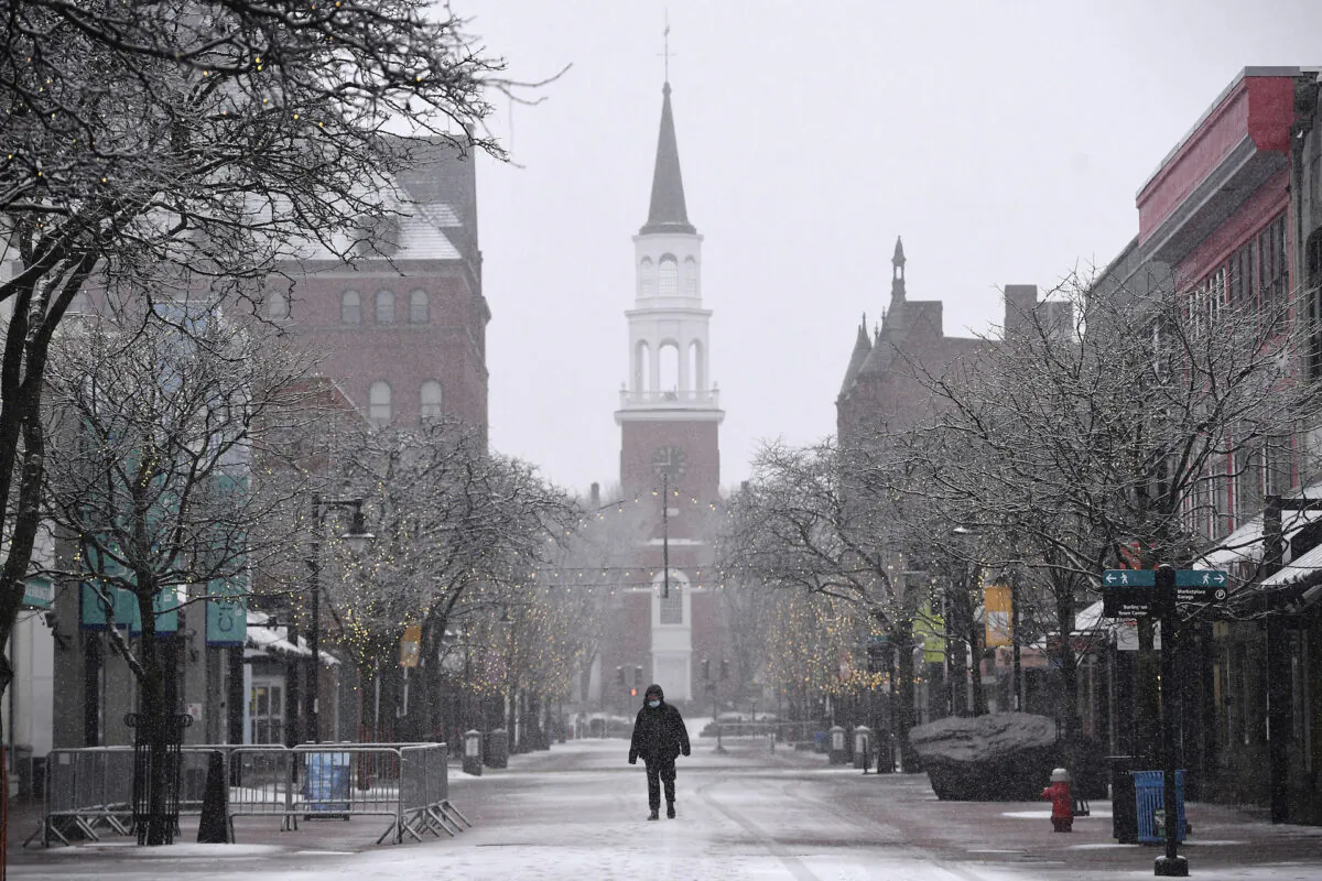 A man walks through Church Street Marketplace during a snowstorm in Burlington, Vt., on March 12, 2022. (Jessica Hill/AP Photo)