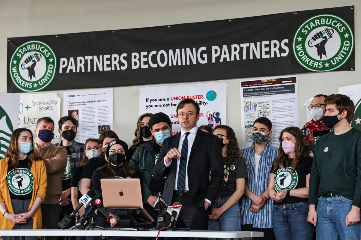 Attorney Ian Hayes and Starbucks workers speak during a news conference to react to a decision by the National Labor Relations Board to postpone a scheduled union vote count in Buffalo, New York, on Feb. 23, 2022. (Brendan McDermid/Reuters)