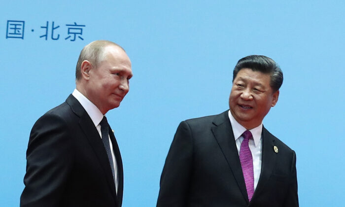 Chinese leader Xi Jinping and Russian President Vladimir Putin smile during the welcoming ceremony on the final day of the Belt and Road Forum in Beijing on April 27, 2019. (Valery Sharifulin/Sputnik/AFP via Getty Images)
