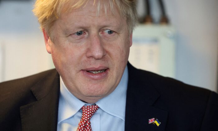 British Prime Minister Boris Johnson wearing pins of the Union Jack and the Ukrainian flag visits the Cammell Laird shipyard in Merseyside on March 10, 2022. (Phil Noble/AFP via Getty Images)