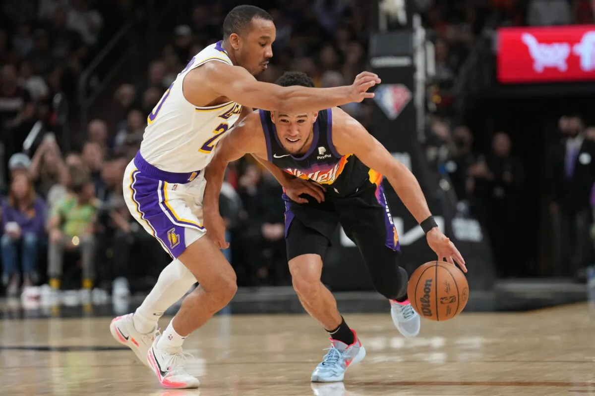 Phoenix Suns guard Devin Booker (1) dribbles against Los Angeles Lakers guard Avery Bradley (20) during the first half at Footprint Center in Phoenix on March 13, 2022. (Joe Camporeale/USA TODAY Sports via Field Level Media)