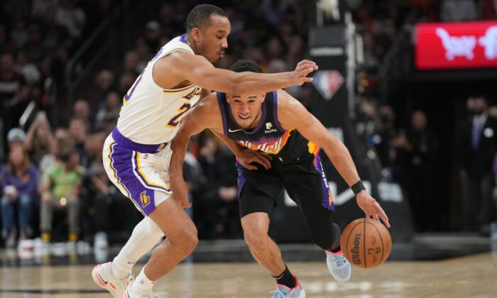 Phoenix Suns guard Devin Booker (1) dribbles against Los Angeles Lakers guard Avery Bradley (20) during the first half at Footprint Center in Phoenix on March 13, 2022. (Joe Camporeale/USA TODAY Sports via Field Level Media)