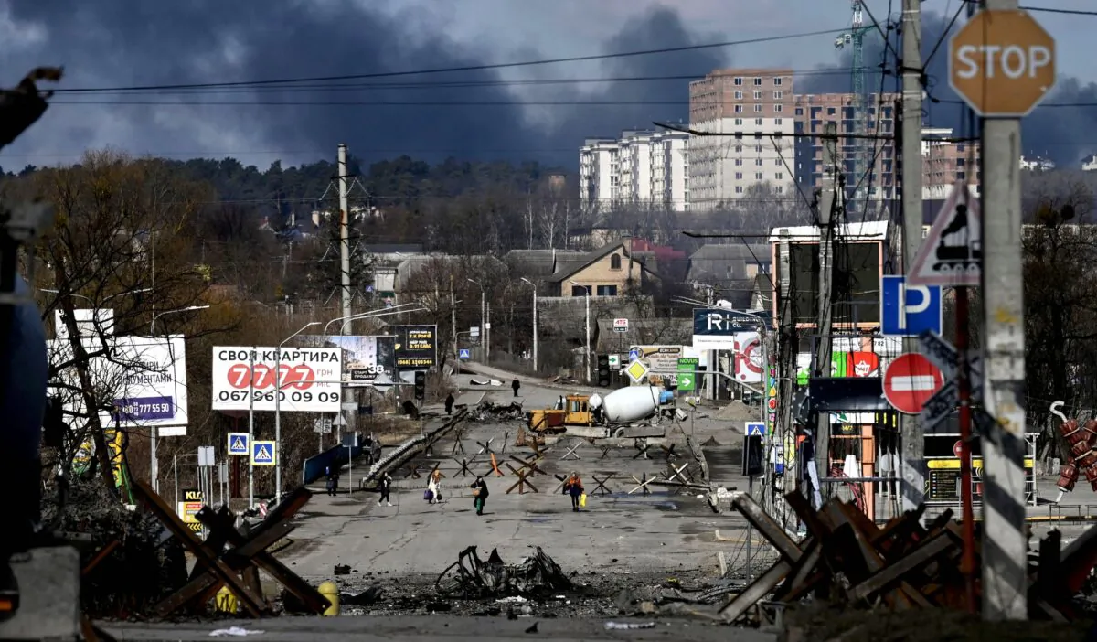 Residents evacuate the city of Irpin, north of Kyiv, Ukraine, on March 10, 2022. (Aris Messinis/AFP via Getty Images)
