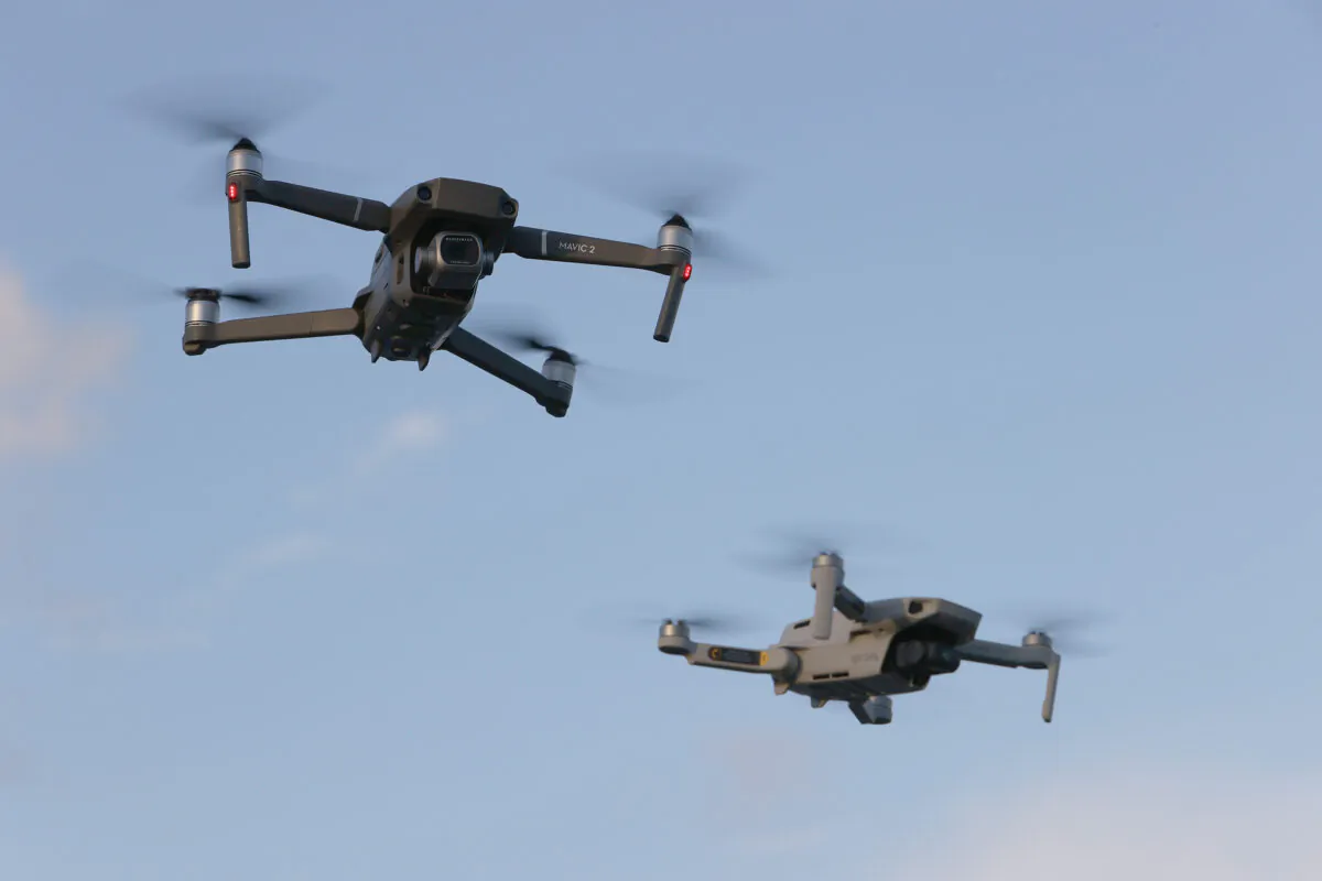Two drones manufactured by Chinese company DJI fly near each other in Miami on Dec. 15, 2021. (Joe Raedle/Getty Images)