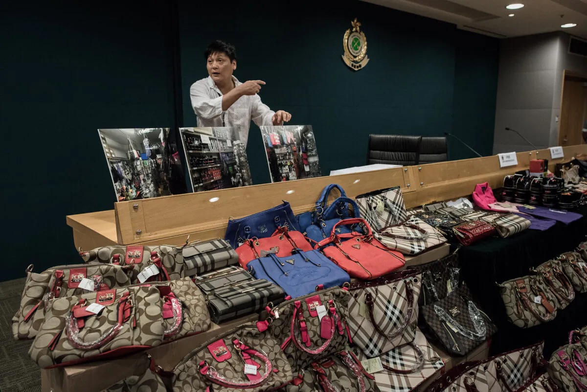 Counterfeit luxury goods are displayed during a press conference following a record seizure at the customs headquarters in Hong Kong on Aug. 6, 2015. (Philippe Lopez/AFP via Getty Images)