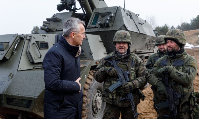 NATO Secretary General Jens Stoltenberg talks with soldiers during a visit of the Adazi military base, north east of Riga, Latvia, on March 8, 2022. (Toms Norde/AFP via Getty Images)