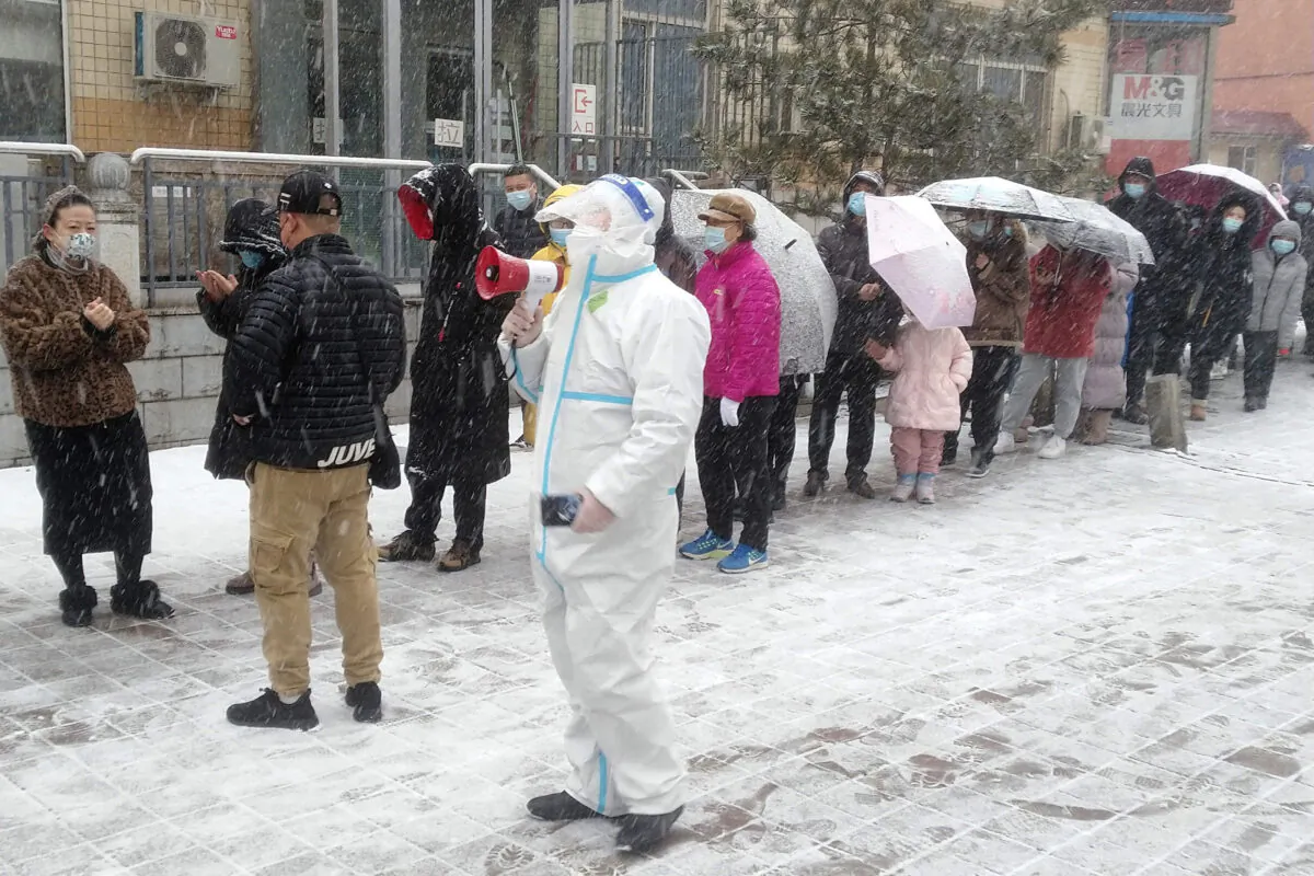 Residents line up for COVID-19 screening during the lockdown in Changchun, in northeastern China's Jilin Province, on March 12, 2022. (Chinatopix Via AP)