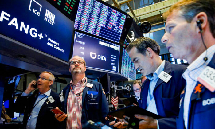 Traders work during the IPO for Chinese ride-hailing company Didi Global Inc. on the New York Stock Exchange (NYSE) floor in New York City on June 30, 2021. (Brendan McDermid/Reuters)
