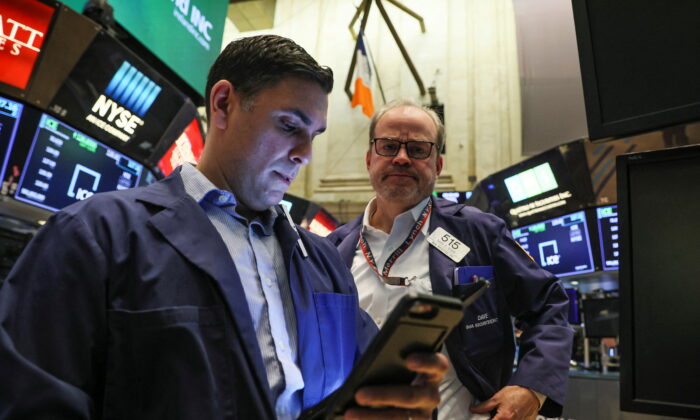 Traders work on the floor of the New York Stock Exchange (NYSE) on March 14, 2022.  (Brendan McDermid/Reuters)