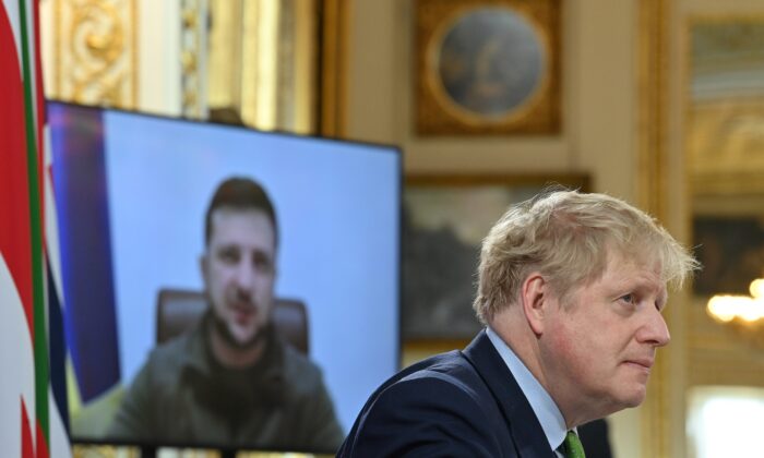 Britain's Prime Minister Boris Johnson (R) listens as Ukraine's President Volodymyr Zelensky addresses by video link a meeting of the leaders of the Joint Expeditionary Force at Lancaster House in London, on March 15, 2022. (Justin Tallis - WPA Pool/Getty Images)