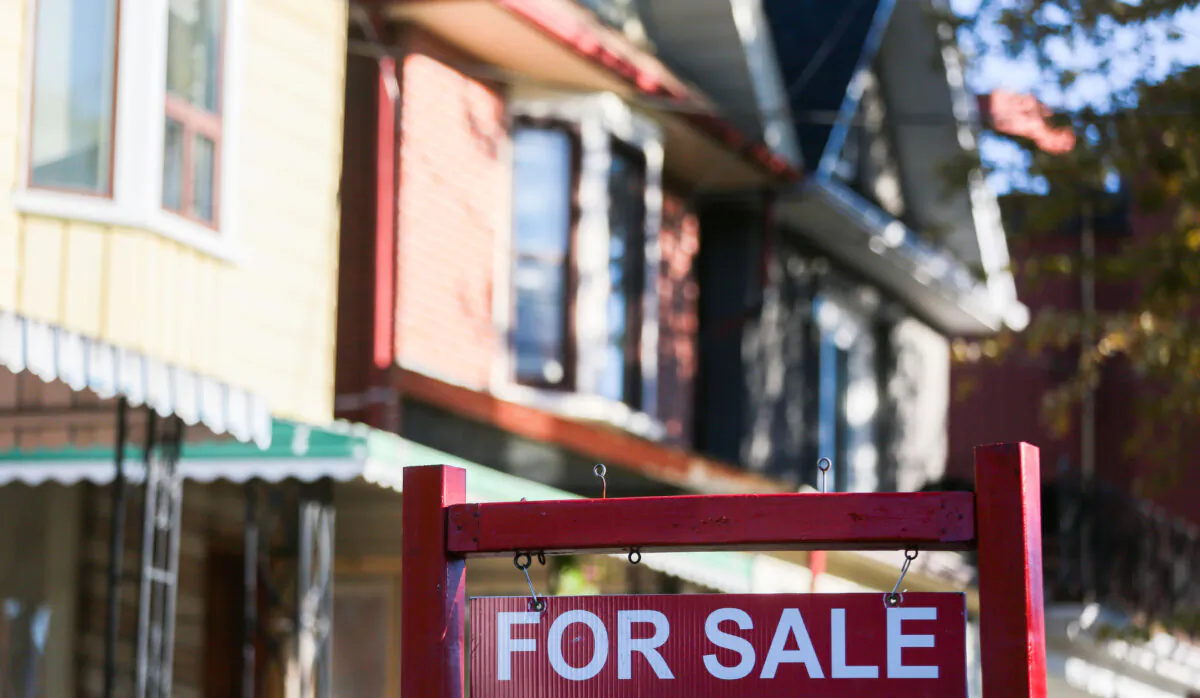 A for sale sign is displayed in front of a house in the Riverdale area of Toronto on Sept. 29, 2021. (The Canadian Press/Evan Buhler)